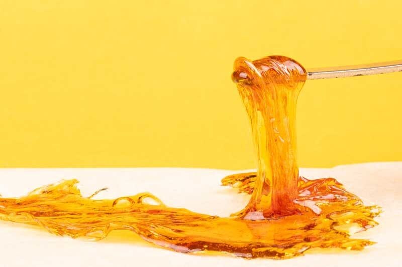 yellow orange cannabis concentrate wax close up, high thc dab resin.
